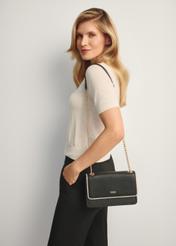 Small black women's handbag TOREC-1015-9J(W26), front view of the product on a model, half of the silhouette visible.