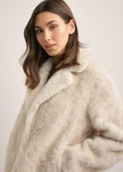 Beige short women's fur coat FUTDP-0058-1A(Z26), close-up of the product detail on the model. Half of the silhouette visible.