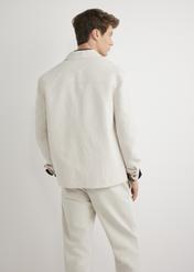 Light beige men's linen jacket KURMT-0420-1A(W26) - back view of the product, on a model, against a light background. Half of the silhouette visible.