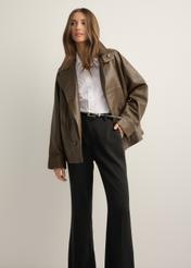 Women's oversize brown leather jacket KURDS-0592-1K(Z26), front view of the product on the model, half of the silhouette visible.