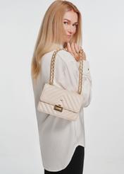 Cream quilted women's handbag TOREC-0528D-12(Z25), front view of the product on the model. Half of the silhouette visible.