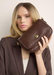 Small brown women's handbag TOREC-1249-1H(Z26) – view of the product held in a model's hand, against a light background.