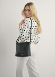 Black leather women's handbag TORES-1265-9I(W26) - front view of the product, on a model, against a light background. Knee-length silhouette visible.