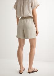 Women's light beige linen shorts SZODT-0019-1A(W26), back view of the product on the model. Half of the silhouette visible.