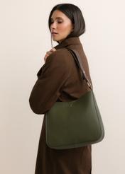 Green women's hobo bag TOREC-1257-8B(Z26), diagonal view of the product, on a model, on a light background. Half of the silhouette visible.