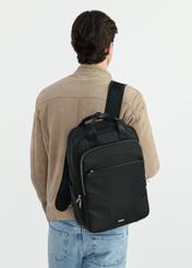 Black travel backpack - small suitcase TOREN-0307-99(W25), front view of the product on the model. Half of the silhouette visible.