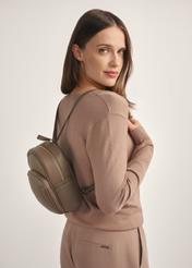 Dark beige leather women's backpack TORES-1089A-1K(W26), diagonal view of the product on the model, half of the silhouette visible.