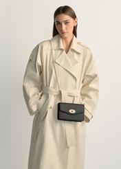 Small black women's handbag TOREC-1141-9I(W26), product view on model's shoulder. Half of silhouette visible.