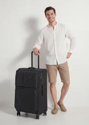 Large suitcase on wheels WALNY-0048-99-28(W26), diagonal view of the product next to the model's silhouette.