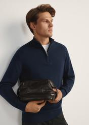 Men's glossy cosmetic bag TORMS-0479-89(Z25), front view of the product on the model, half of the silhouette visible.