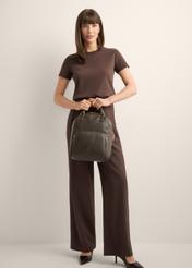Women's brown leather backpack TORES-1146-1I(Z26), product view in model's hands. Full body visible.