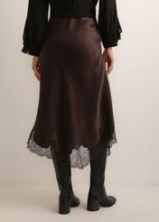 Dark brown asymmetrical women's skirt SPCDT-0135-1I(Z26), product view from the back on the model. Half of the silhouette visible.