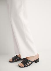 Women's leather mules with a block heel BUTYD-1265-99(W26), side view of the product on the model's feet.