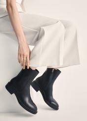 Black leather women's ankle boots BUTYD-1033-99(Z25), product view on model's feet against a light background.