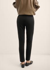 Black fitted women's trousers SPODT-0096-99(Z25), back view of the product on the model. Half of the silhouette visible.