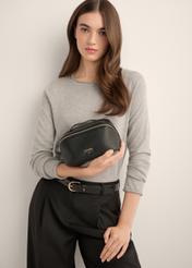 Black women's cosmetic bag TOREC-1310-9I(Z26), view of the product in the model's hand. Half of the silhouette visible.