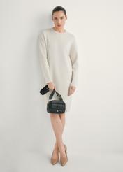 Small black women's handbag TOREC-1174-99(W26), view of the product in the model's hand. Full body visible.