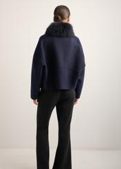 Women's short wool fur coat in navy blue FUTDW-0038-7E(Z26), back view of the product on the model. Half of the silhouette visible.