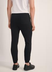 Black men's sweatpants SPOMT-0101-99(Z25), product view from the back on the model, half of the silhouette visible.