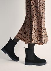 Women's black suede Chelsea boots BUTYD-1194-99(Z25) - side view of the product on a model against a white background. Half of the silhouette visible.