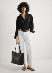 Brown women's shopper bag TOREC-1235-1H(W26), product view in model's hands. Full body visible.