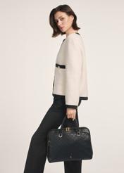 Black large women's bag TOREC-0978A-98(Z25), product view from the front on the model, half of the silhouette visible.