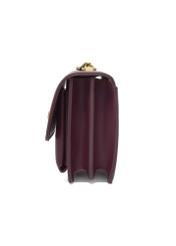 Small burgundy women's handbag with an elegant clasp TOREC-1322-4D(Z26), side view of the product on a white background.