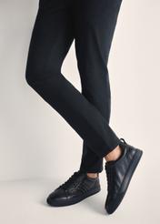 Black men's leather sneakers BUTYM-0465-99(Z25), product view on model's feet against a light background.