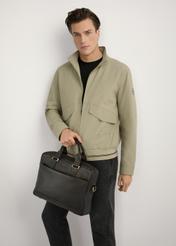 Brown men's leather briefcase TORMS-0503-1I(W26) - front view of the product, held in the model's hand, against a light background, visible silhouette up to the knees.