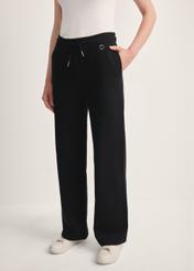Black women's trousers SPODT-0111-99(Z25), front view of the product on the model. Half of the silhouette visible.
