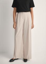 Light beige women's trousers SPODT-0119-1A(W26), front view of the product on the model. Half of the silhouette visible.