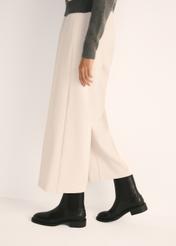 Black leather women's ankle boots BUTYD-1032-99(Z25), product view on model's feet against a light background.