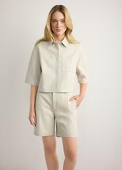 Women's cream leather shorts SPODS-0047-0B(W26), front view of the product on the model. Half of the silhouette visible.