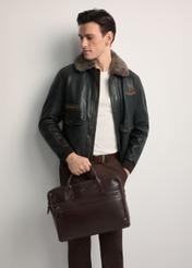 Brown leather men's bag TORMS-0460-1H(Z26) - front view of the product, held by the model. Half of the silhouette visible.