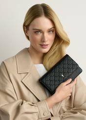 Small women's handbag in black TOREC-1178-9P(W26), view of the product in the model's hand, on a light background.