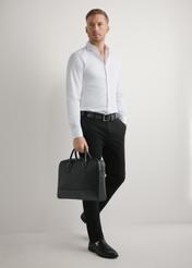 Black leather laptop bag TORMS-0494-99(W26) - slightly diagonal view of the product, held in the model's hand, against a light background.