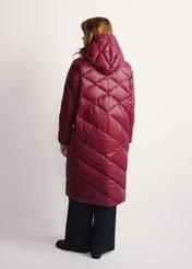 Long burgundy women's winter jacket KURDT-0542A-49(Z25), back view of the product on the model, the whole silhouette is visible.