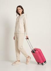 Small suitcase on wheels WALAB-0040-5E-19(W26), product view diagonally next to the model, the entire silhouette is visible.