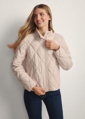 Beige women's quilted jacket KURDT-0658-1A(W26), front view of the buttoned-up product on the model. Half of the silhouette visible.