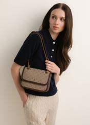 Beige women's handbag with a monogram (TOREN-0360-1B(Z26)); front view of the product shown on a model's shoulder.