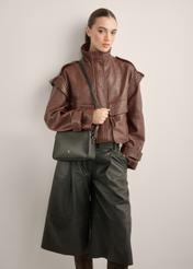 Small black leather women's handbag TORES-1353-99(Z26), diagonal view of the product on the model. Half of the silhouette visible.