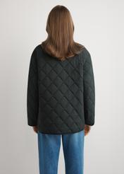 Women's black quilted jacket KURDT-0580-99(W26) - back view of the product, on a model, against a light background. Knee-length silhouette visible.