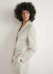 Women's light beige linen blazer ZAKDT-0049-1A(W26), front view of the product on the model. Half of the silhouette visible.