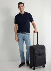 Medium suitcase on wheels WALNY-0048-99-24(W26), diagonal view of the product next to the model's silhouette.