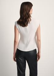 White elegant women's blouse BLUDT-0195-12(Z25), product view from the back on the model, half of the silhouette visible.