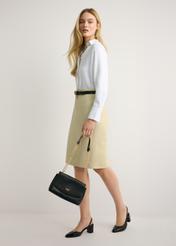 Black chain messenger bag TOREC-1152-99(W26) - front view of the product, held by the model, against a light background. The entire silhouette is visible.