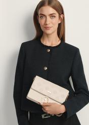 Cream monogrammed women's handbag TOREC-0536-0B(W26), product view in model's hand. Half of silhouette visible.