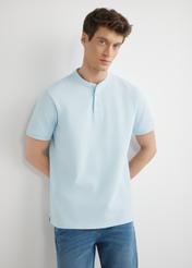 Light blue men's polo shirt POLMT-0095-7A(W26), front product view on model. Half silhouette visible.