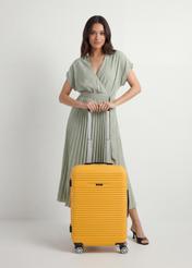 Medium suitcase on wheels WALAB-0040-2B-24(W26), product view from the front with the model, the entire silhouette visible.