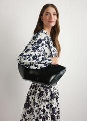 Black women's shoulder bag TOREC-1237-99(W26) - front view of the product, on a model, against a light background. Half of the silhouette visible.